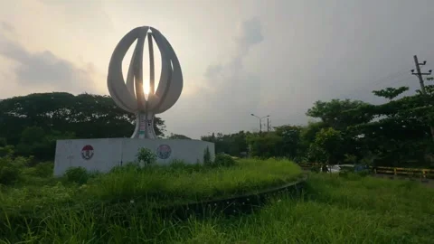 Sunset Through Circular Structure Surrounded by Grass at Dhaka, 5 July, 2025 Stock Footage 314207961