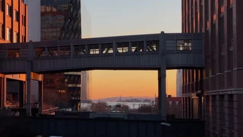 Sunset through a city walkway, showcasing the vibrant atmosphere of urban life 스톡 동영상 291510401
