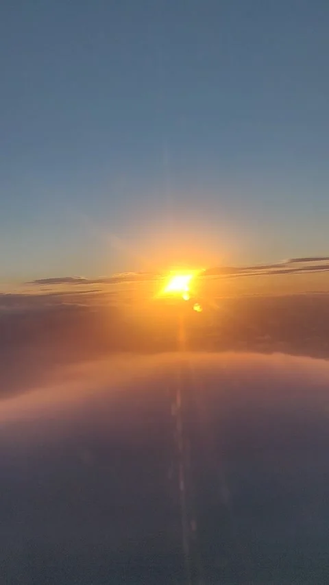 Sunset Through the Clouds on Airplane Stock Footage 168905741
