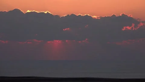 Sunset through the clouds over the sea in fast motion Stockbeeldmateriaal 245828350