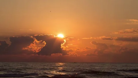 Sunset through the clouds on water - Timelapse Stock Footage