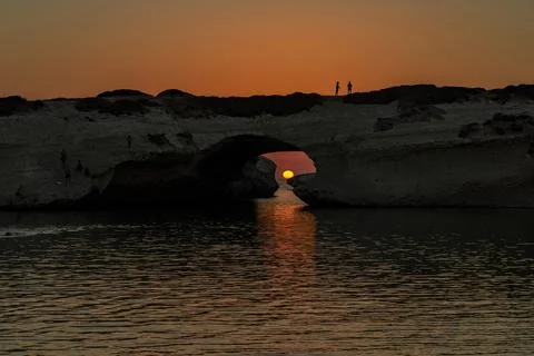 Sunset through the crack of a rock Stock Photos