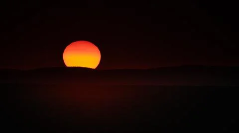 Sunset through the desert dust over the desert in Damaraland, Namibia, Africa Stock Photos
