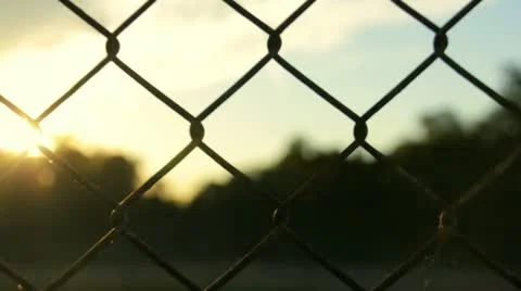 Sunset Through Fence Stock Footage 12590029