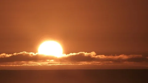 Sunset Through Final Cloud Layer Time Lapse Over Sea Stock Footage 126946127