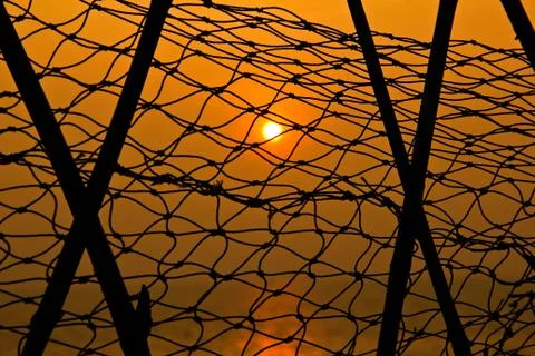 Sunset through fishnet. Stock Photos