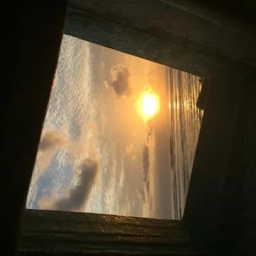 Sunset through hole in boat Stock Photos