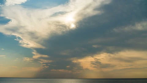 Sunset through the rainy clouds over ocean. Timelapse. Stock Footage 87935595