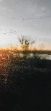 Sunset through scratched window Stock Photos