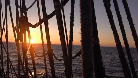 Sunset through the shrouds and rigging of an old sailing ship. Stock Footage 124946125