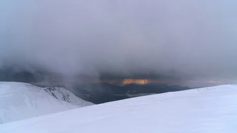 Sunset through the snow storm in the winter mountains time lapse Stock Footage 100990525