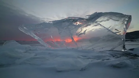 The sunset through the transparent ice in motion Stock Footage 84689804