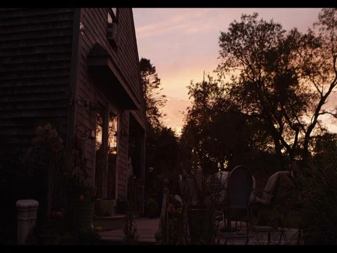 Sunset through the Trees next to House in Jamestown Rhode Island Video stock 76658659