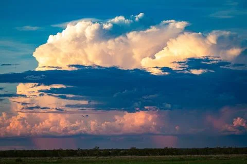 Sunset thunderstorm settles in during north Australian wet season Stock Photos