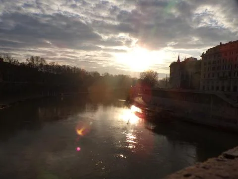 Sunset on the tiber river, Rome Photos