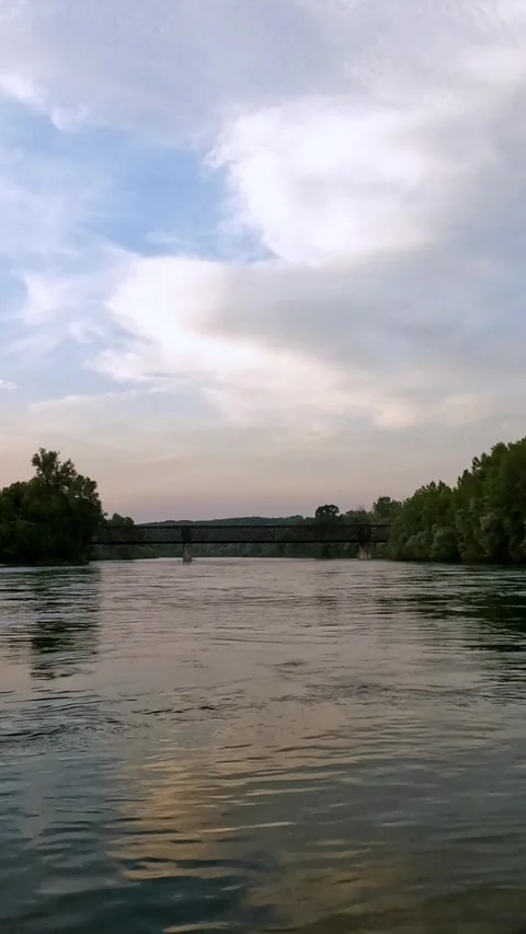 Sunset on the Ticino river with iron bridge, vertical video Stock Footage 311032068