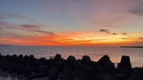 Sunset time at beach with orange sky 4K video Stock Footage 238859815