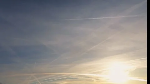 Sunset time-lapse with aircraft trails in the sky over mountain peaks. Stock Footage 302586846