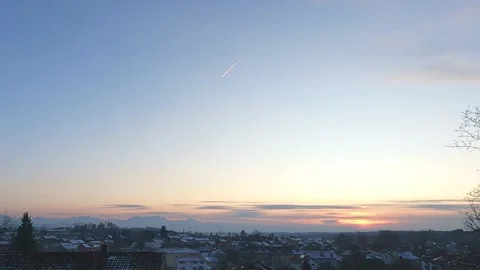Sunset time-lapse with aircraft trails in the sky over mountain peaks. Stock Footage 302586920