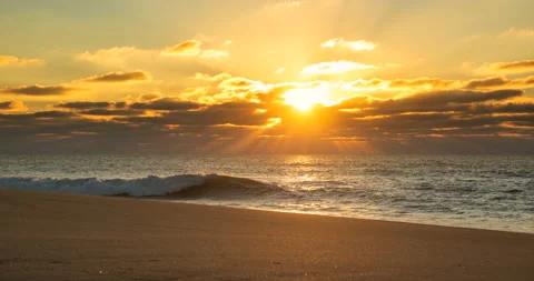 Sunset time lapse on beach. Rays of sunlight shining through gaps in clouds Видео 146669134