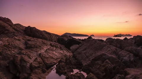 Sunset Time Lapse Beach Rocks over sea with boats passing Stock Footage 58887877