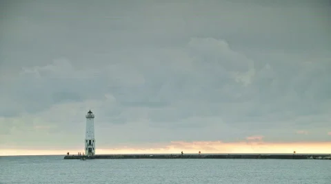 Sunset time-lapse beyond a lighthouse Stock Footage 527027