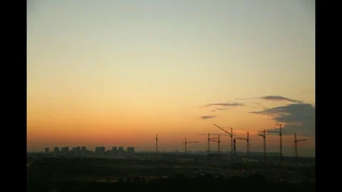 Sunset Time-lapse, building construction with many cranes on horizon Stock Footage 78940225