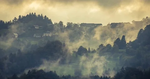 Sunset time lapse with clouds moving over settlement on hilltop Stock Footage 140800414