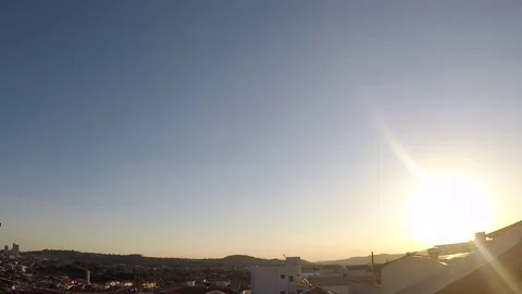 Sunset time lapse in a country town seen from a rooftop - FullHD Stock Footage