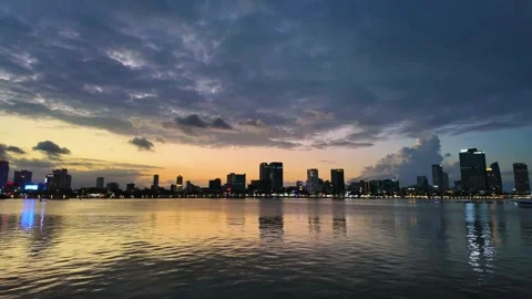 Sunset time lapse of dark clouds over Da Nang skyline and Han River Stock Footage 347989304