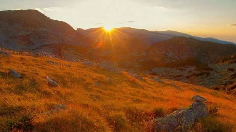 Sunset time lapse dawn with flowing cloud waves above mountain peaks and valley Stock Footage 83136973