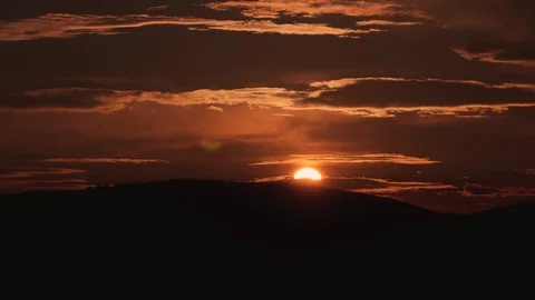 Sunset time lapse with moving clouds over the hills Stock Footage 90703510