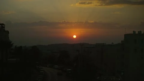 Sunset time lapse,The orange rays of the sun emerge from the clouds and create 스톡 동영상 301673508