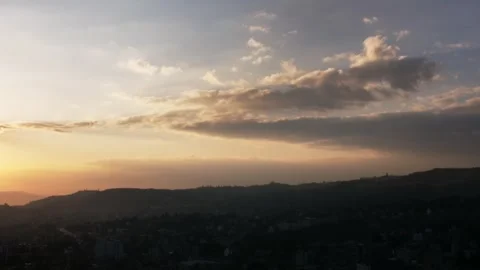 Sunset Time lapse over Addis Ababa mountains clouds and sun moving turning to Stock Footage 328290446