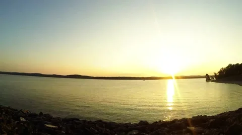 Sunset time lapse over lake with some boats. Video stock 55496240