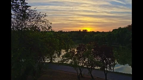 Sunset Time Lapse Over Lake in Tineretului Park Bucharest, Lights Turning On Video stock 347593641