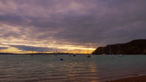 Sunset time lapse over ocean with yachts in Russell, New Zealand Stock Footage 114712696