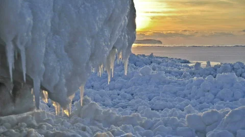 Sunset time-lapse over shoreline ice formations. Stock Footage