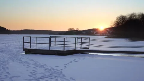 Sunset time lapse over a winter lake and a dead pier. ice fishing Stock Footage 168363221
