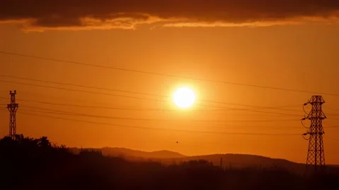 Sunset time lapse with pylon and mountain silhouette. Stock Footage 131334898