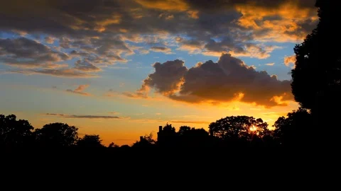 Sunset time lapse shot behind forest Stock Footage 99288531