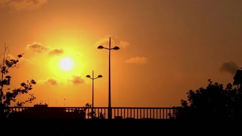 Sunset Time lapse skyline city silhouette on a bridge, people walking and riding Video stock 134205024