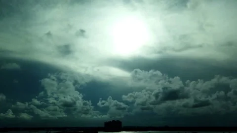 Sunset time lapse through the clouds tilting down to Palm Beach shores Bay Stock Footage 214194253
