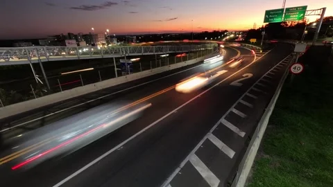 Sunset time-lapse of vehicle traffic at the intersection of highways Video stock 322943608