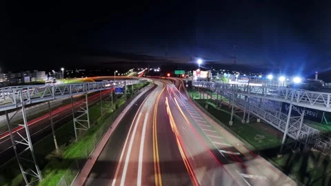 Sunset time-lapse of vehicle traffic at the intersection of highways Stock Footage 328484750