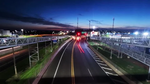 Sunset time-lapse of vehicle traffic at the intersection of highways Video stock 329539860