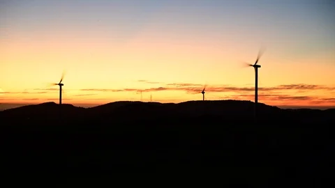Sunset time lapse of windmill turbines and possible ufos, original version Stock Footage 125464574