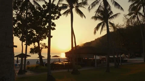 Sunset time on tropical beach resort. Warm light. Holidays and vacation Stock Footage 268734745