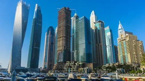 Sunset time view from promenade Dubai Marina modern towers and floating yachts Stock Footage 86361644