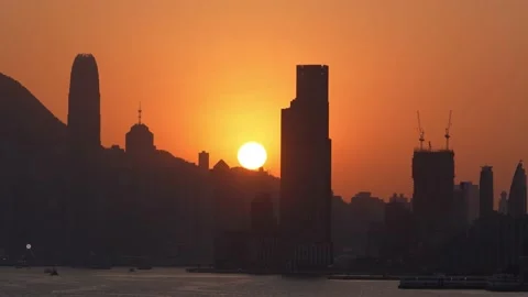 Sunset timelaps, the sun going down in skyscrapers, Victoria Harbour, Hong Kong Stock Footage 232398487